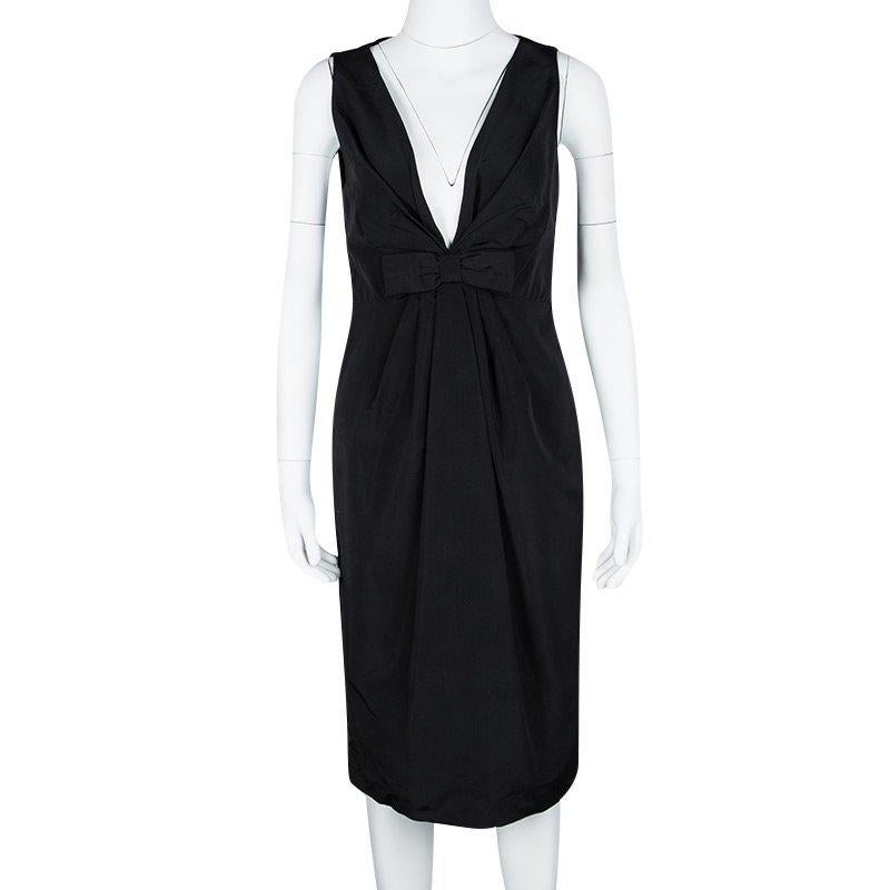 Elegant and classy, this is one dress that every woman dreams of having. Beautifully made from cotton and silk in Italy, this Valentino sleeveless dress has a lovely black hue, a plunging neckline and a bow at the front. It also has a calf-length