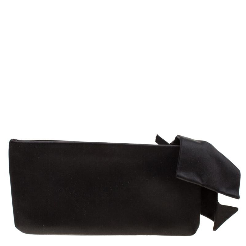 This clutch by Valentino is what you would carry on an evening out. The black satin exterior is simply detailed with a lovely oversized bow and a top zip closure. The satin interior will easily hold your little essentials.

Includes: The Luxury