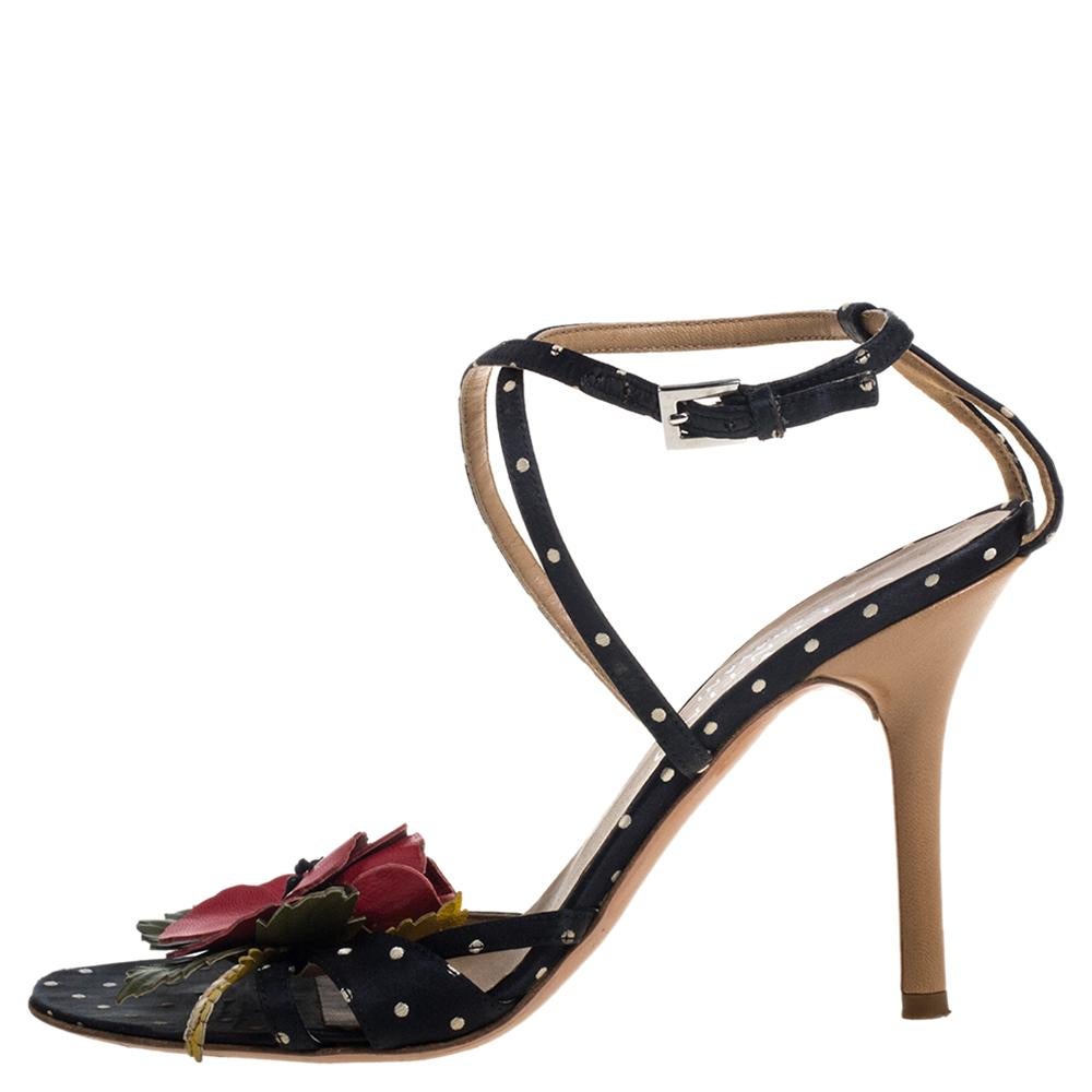 Turn heads and leave admirers in awe as you twirl around in these stunning sandals by Valentino. Crafted in Italy, they are made from satin and carry a black hue. Aside from the playful polka dots, the statement-making floral embellishments on the