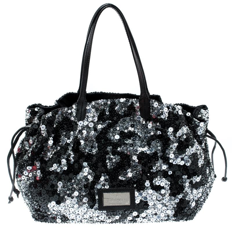 This elegant bag by Valentino will surely leave you spellbound. Made from leather and covered in sequins, the bag features drawstrings on the sides, two top handles, and a spacious satin interior. Glam up your wardrobe with this piece.

Includes: