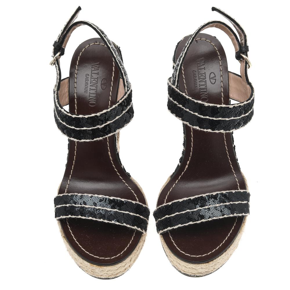 Embellished with black sequins and designed in an open-toe style, these Valentino sandals are about comfortable style. They feature buckle fastening and high wedge heels.

