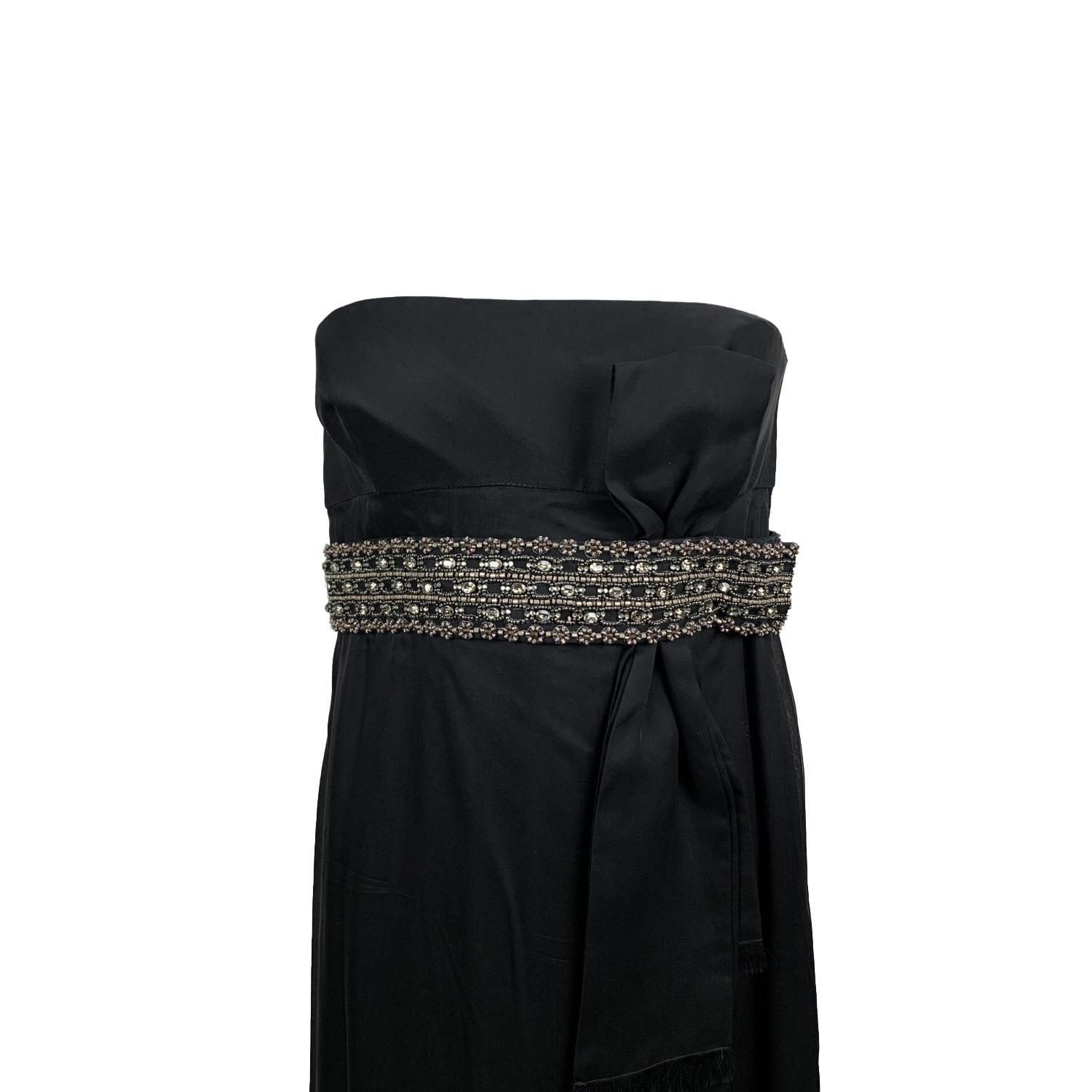 Stunning Valentino bustier black silk gown from the 2008 winter collection. The dress features a jeweled and beaded embelished waist belt (not removable) with bow detailing. Strapless design with built-in bra. Side zip closure. Composition: 100%