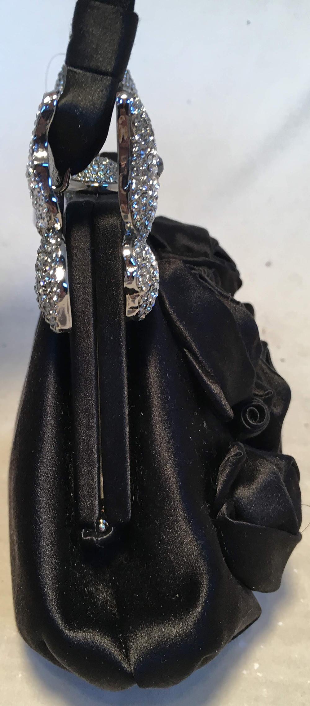 Valentino Black Silk Rose and Swarovski Crystal Butterfly Evening Bag in excellent condition. Black silk exterior trimmed with silver hardware, black silk rosettes along the front side, and swarovski crystal covered butterflies at the top ends of