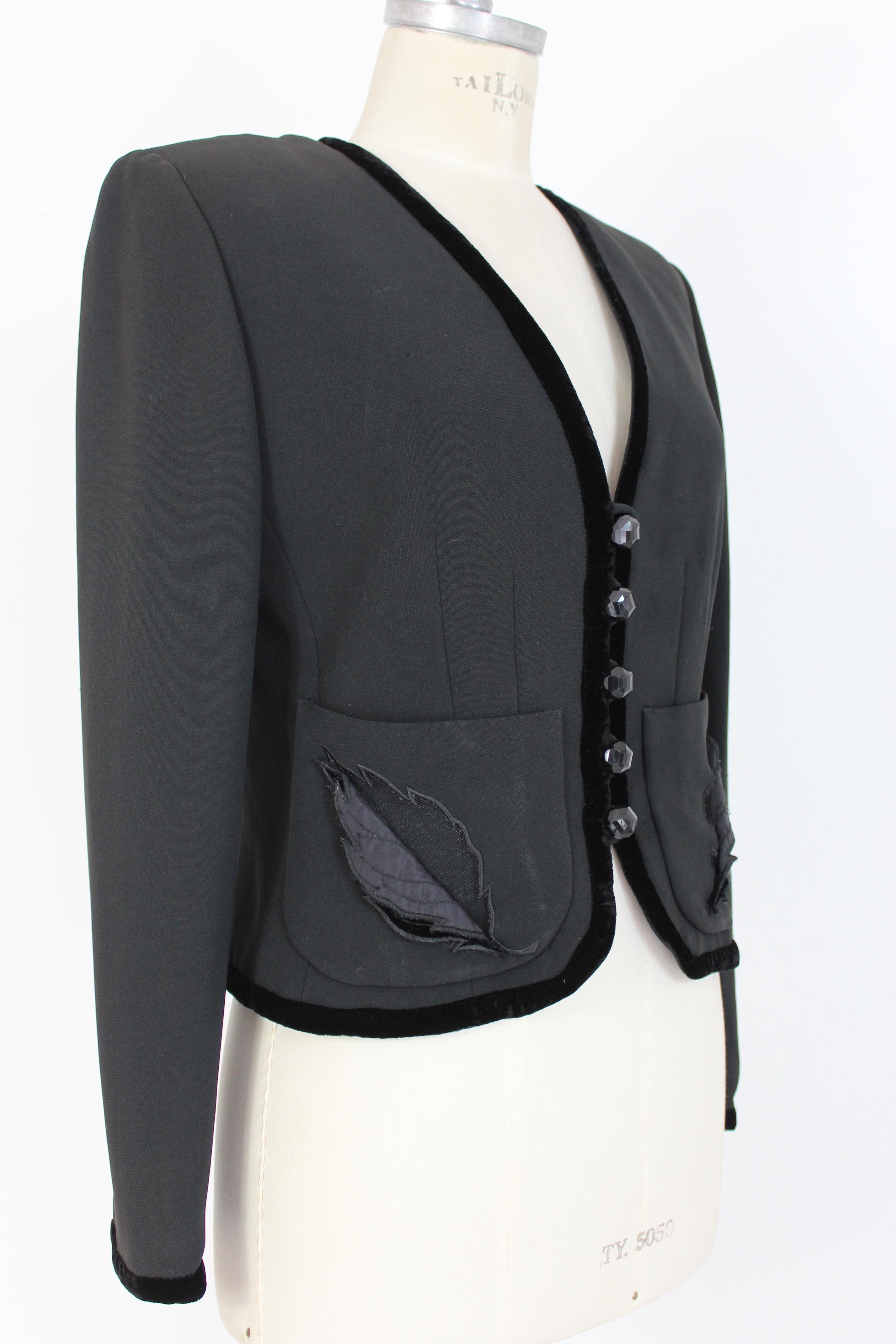 Valentino Miss V 90s vintage women's jacket. Short model, evening jacket. Black color, velvet edges, on the pockets there are velvet and lace leaves. Closure with jewel buttons. Fabric 53% acetate 47% viscose. Lined interior. Made in Italy.