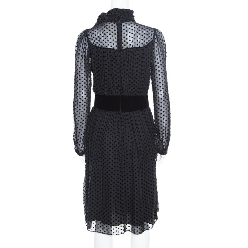 Beautifully adorned with polka dots all over creating an elegant embroidery, this pretty dress from Valentino is ideal for special events. The well-fitted silhouette and classic black hue combine to make it as sophisticated as chic it is. The piece