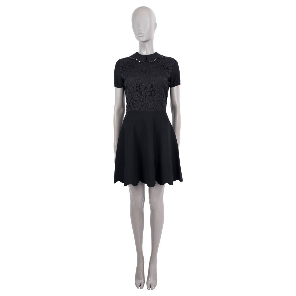 100% authentic Valentino short sleeve mini dress in black viscose (83%) and polyester (17%) with a lace top part and black Rockstud embellished scalloped peter pan collar and hem. Opens with a hidden back zipper. Lined in silk (91%) and elastane