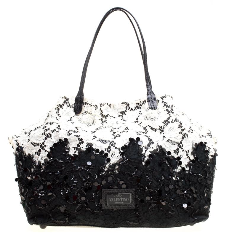 Rich in details and brimming with artistic excellence, this stunning tote from Valentino needs to be on your wishlist! Ethereal in black and white, this tote is crafted from lace and leather and is beautifully embellished with sequins. It flaunts