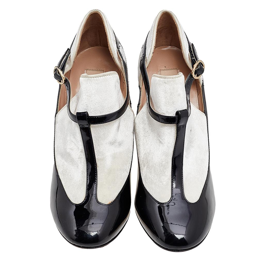 Valentino is known to design luxe styles like these T-strap pumps. These pumps are made using black-white patent leather and velvet on the exterior with gold-toned hardware used to adorn their fittings. Complement your outfit by wearing these