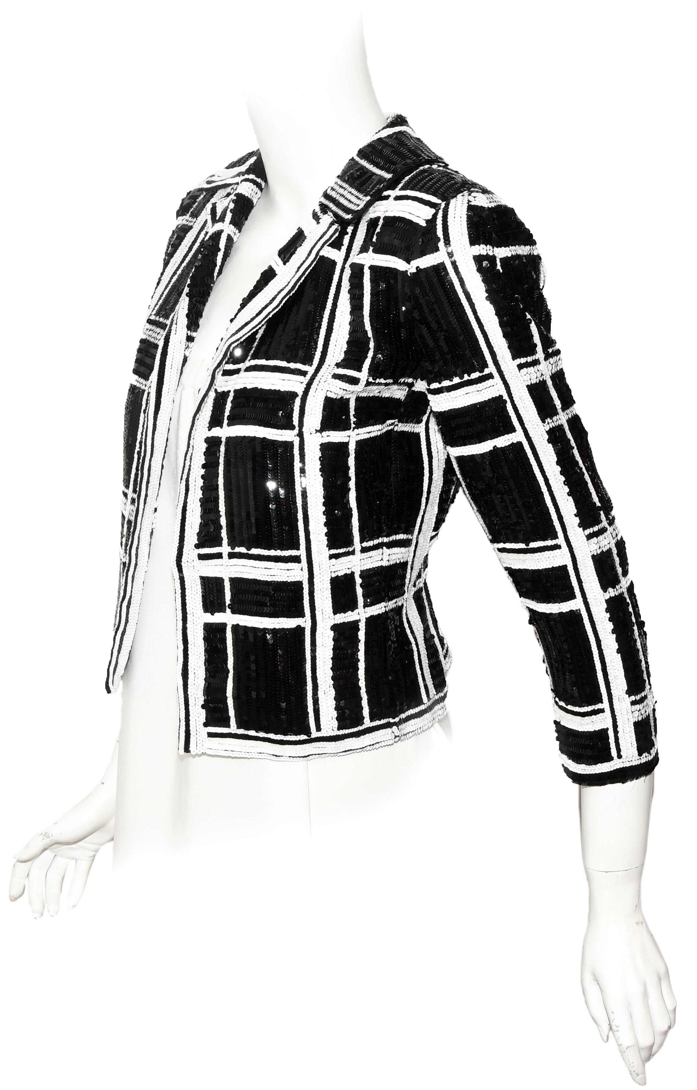 Valentino black and white check design is created with the sequins not the fabric. This crop jacket contains 3/4 sleeves and notch collar.  It does not include buttons nor any other closures, it is open at front.  It is perfect for those spring and