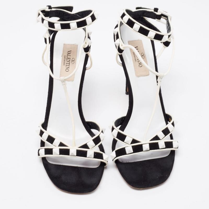 The addition of Rockstud to these Valentino sandals leads to their instant identification. Created from suede and leather, they are teamed with a T-strap, an ankle buckle closure, and 10.5cm heels. The combination of black and white shade offers