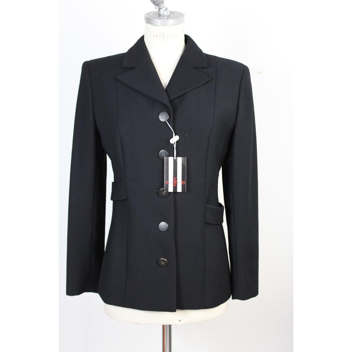 Valentino suit jacket and black trousers in pure wool, new with label. The jacket has a belt behind the back. The trousers have a slit on the bottom, two pockets on the sides and a band on the entire length.

Size 42 It 8 Us 10 Uk

Shoulders: 42