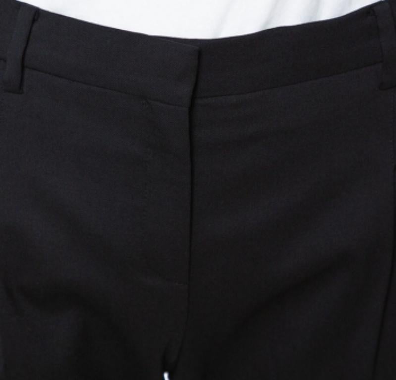 How smart and stylish do these tailored trousers from Valentino look! The black trousers are made of wool and feature a simple structured silhouette. They come equipped with four slip pockets and a zip closure. Pair with formal shirts and pumps.