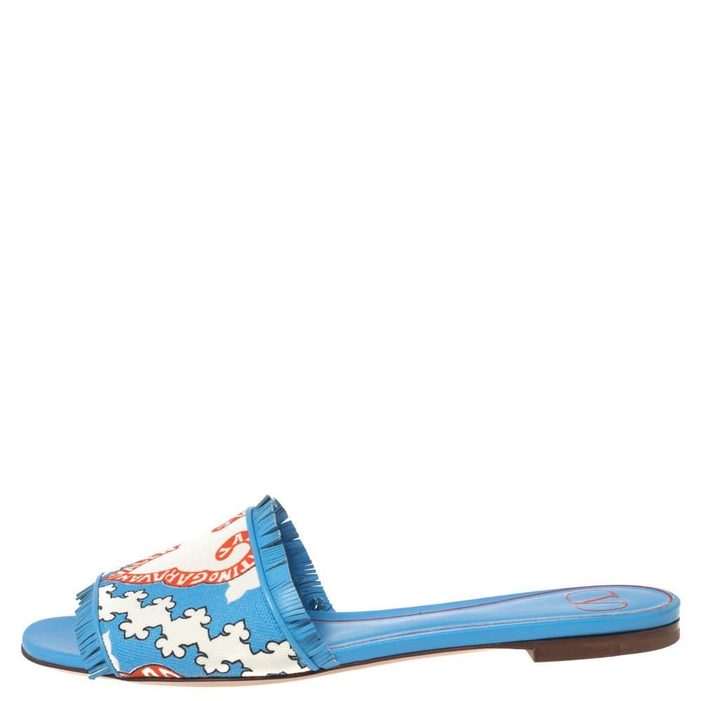 Beautifully detailed, these slides from the House of Valentino bring out the gracefulness and simplicity in every woman. Their upper is made from blue canvas, which is augmented with a colorful print. They feature a leather lining and a slip-on