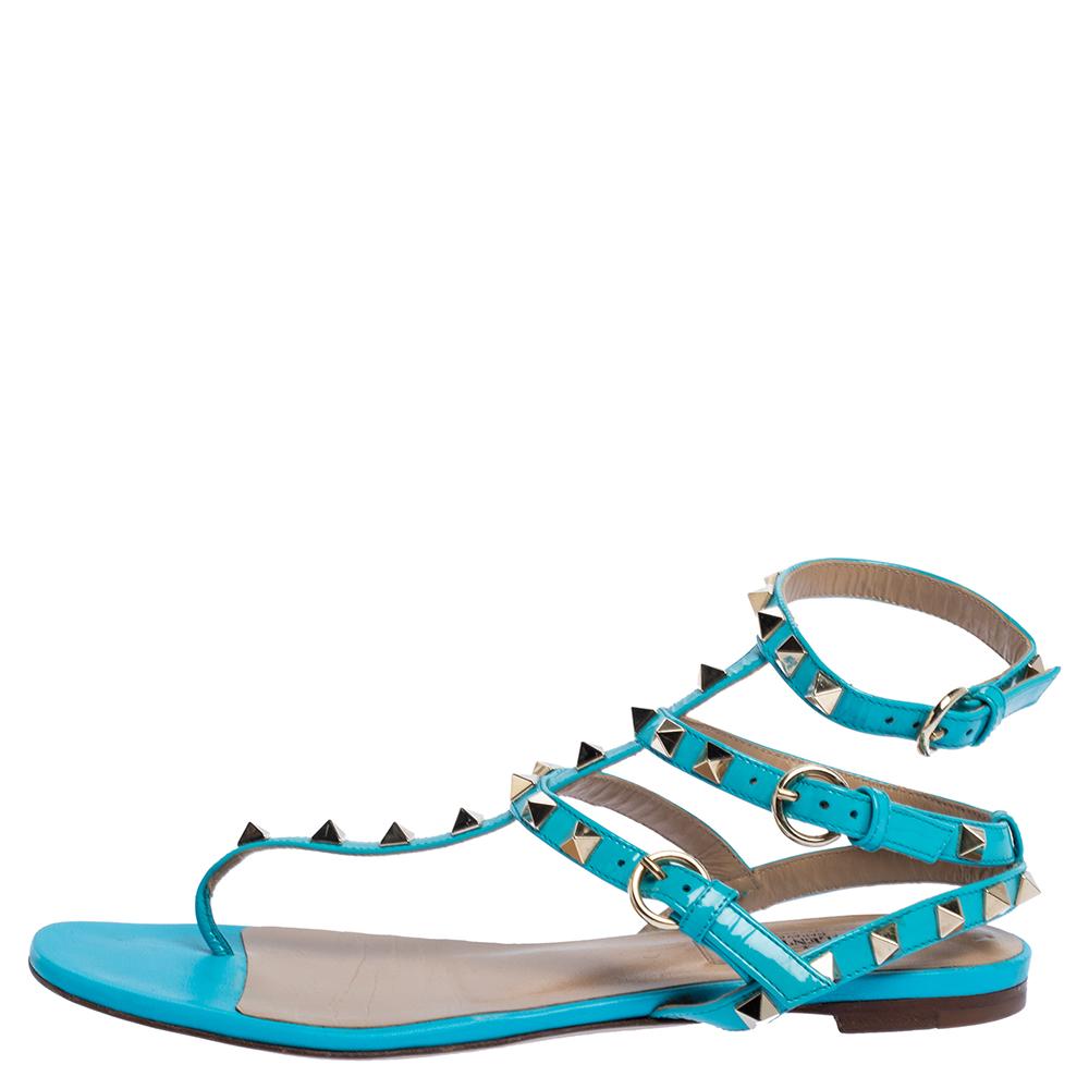 The joy of comfort is the main idea of this blue pair by Valentino. Crafted in Italy, the flat sandals are made from patent leather in a thong design and are graced with signature studs.

