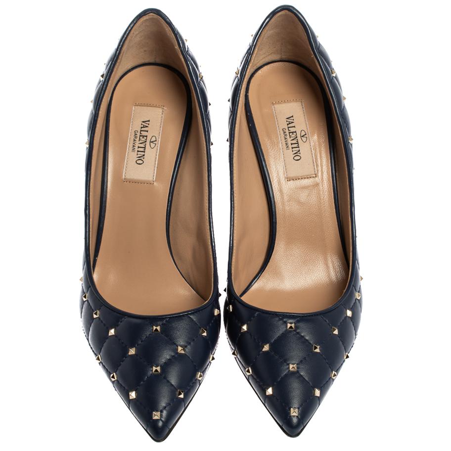 Do modern chic with these pumps from Valentino. Crafted with blue leather, the pair has a quilted exterior that adds a polished finish to this bold piece. It is graced with silver-tone studs throughout the pointed-toe silhouette along with stiletto
