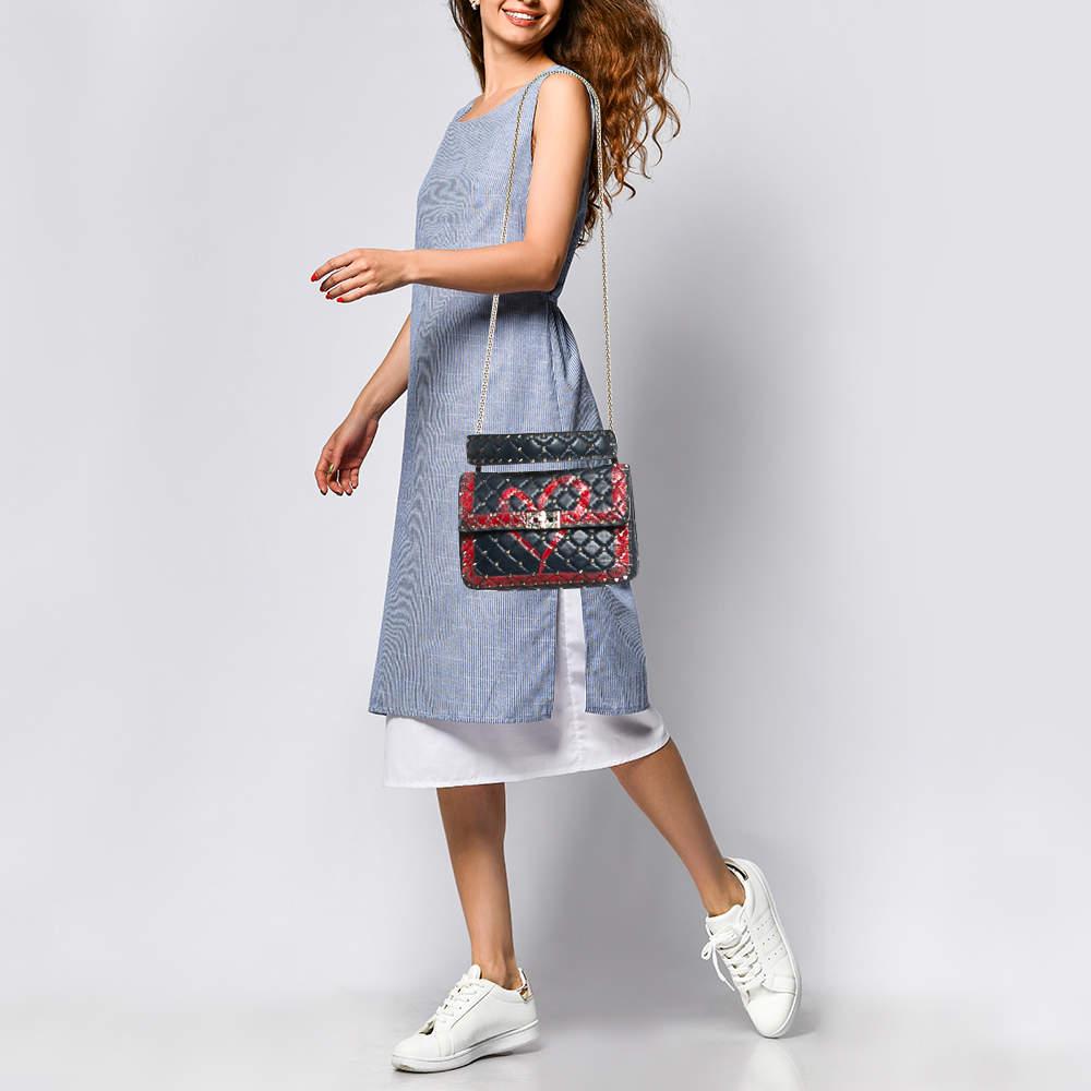 The Valentino Rockstud Spike bag will help you create a statement making look. It is secured by a twist lock on the flap and punctuated with the labelâ€™s signature Rockstuds  each artfully placed on the quilted leather exterior and flaunts a heart