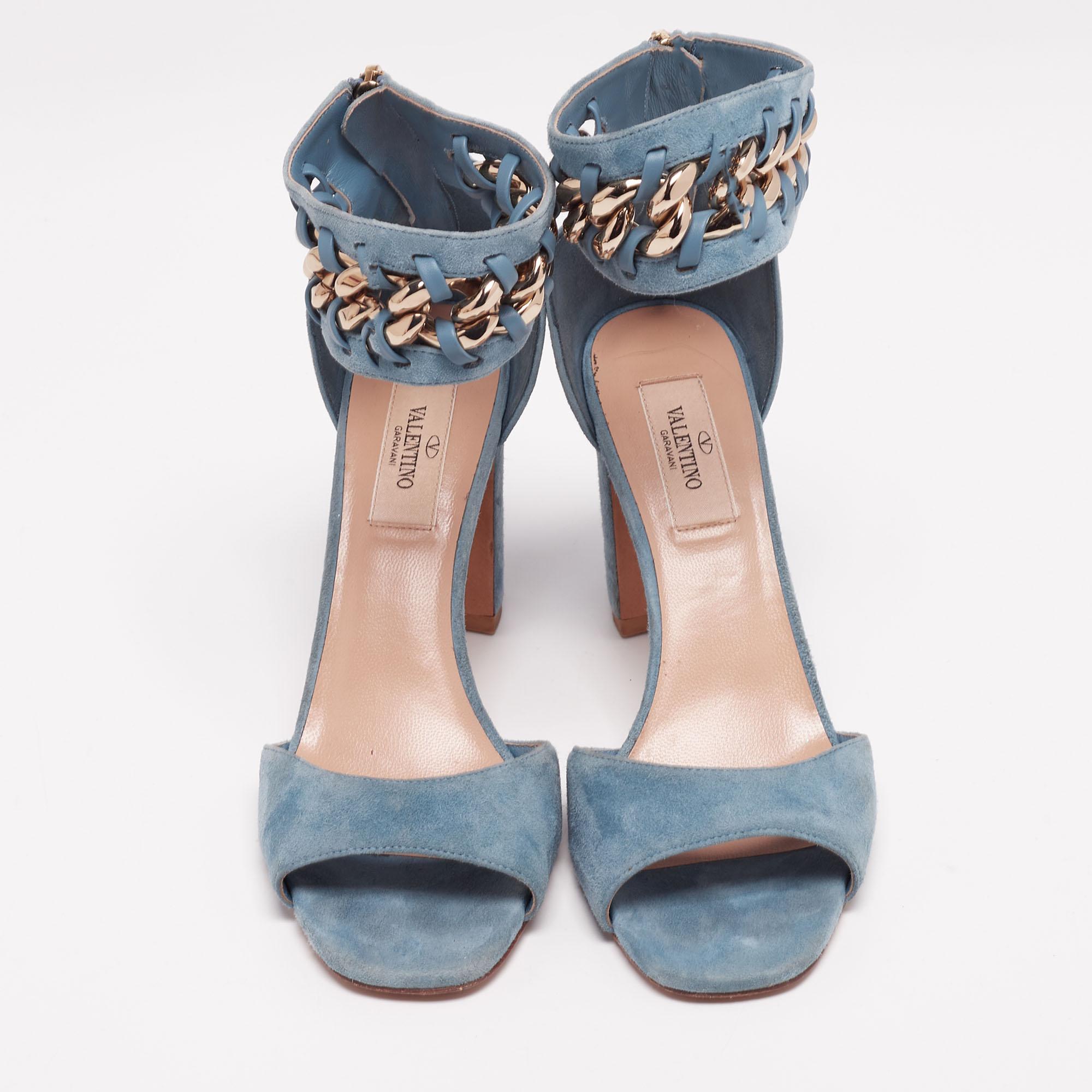 These sandals from the House of Valentino are all about class and elegance! They are made from blue suede, with a chain-link accent embellishing the ankle cuff. They have open toes, gold-tone hardware, and block heels. Make a fashion statement as
