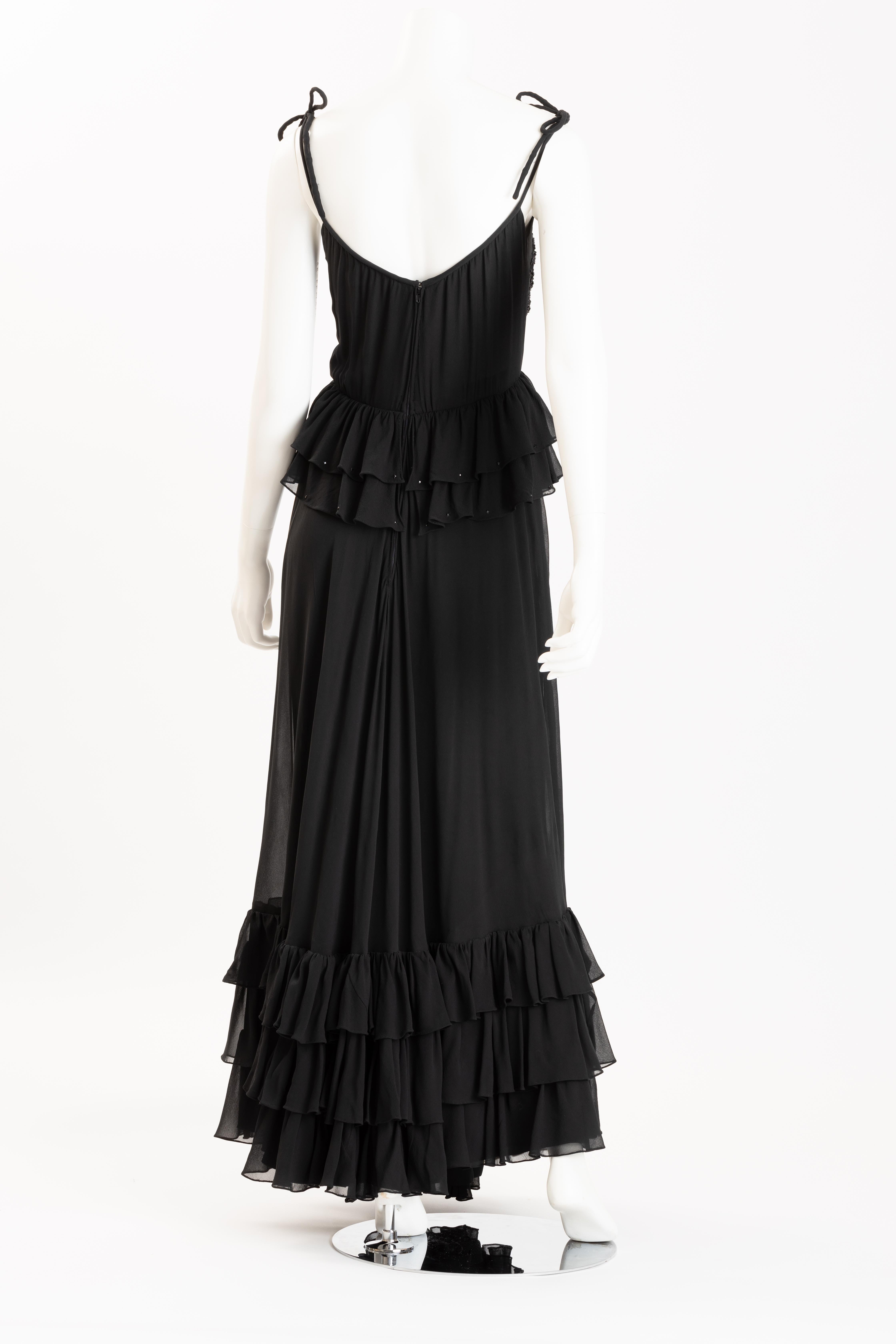 Luxurious Valentino Boutique black silk evening gown with tiered ruffles, sweeping hemline and hand beaded and embroidered bodice. Two ruffles at bodice are hand beaded with tiny jet palletes.
Gown features hand rolled silk ties at shoulders, and