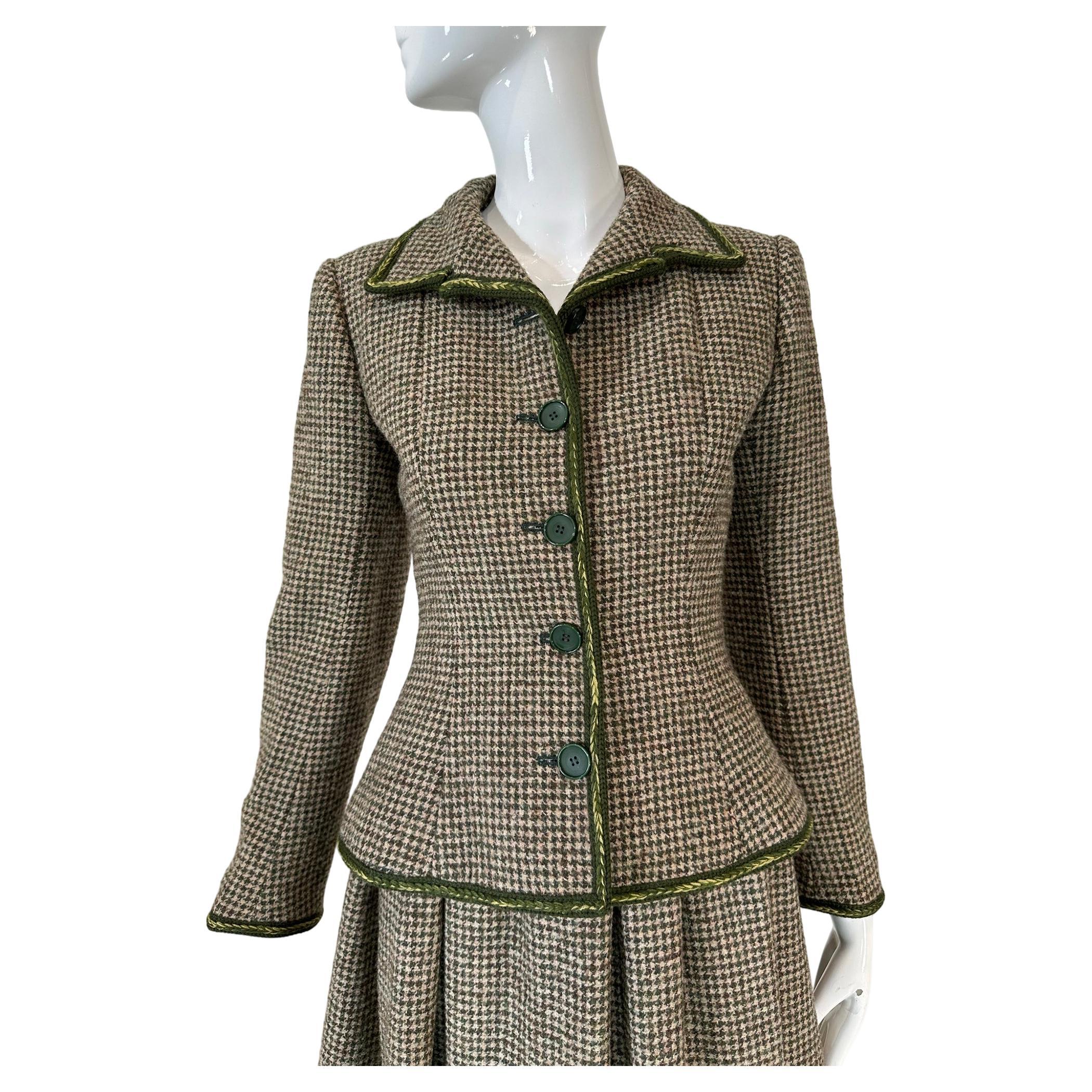 Valentino Boutique early 1960s wool tweed skirt suit, a nod to Christian Dior's Bar suit. Done in a moss green & cream dog tooth check, the jacket & skirt are trimmed in coordinating olive green & yellow wool braid trim. The long sleeve jacket