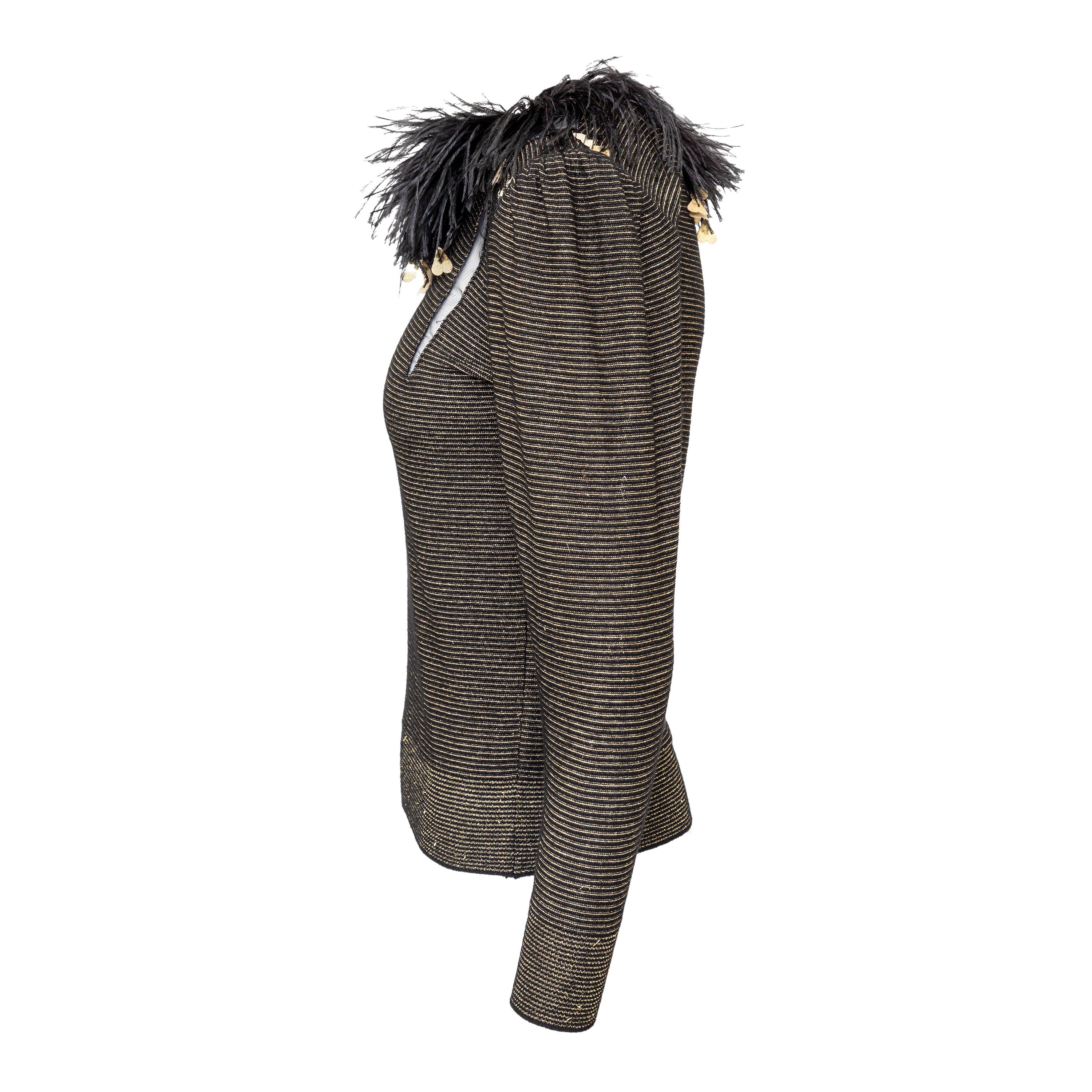 This vintage 80s Valentino Boutique Feather Trim Top adds a touch of luxury to any outfit. The gold lurex stripe with mesh accents creates a glamorous look, while the feather trim around the neck adds a unique and stylish touch. The ribbed hem at