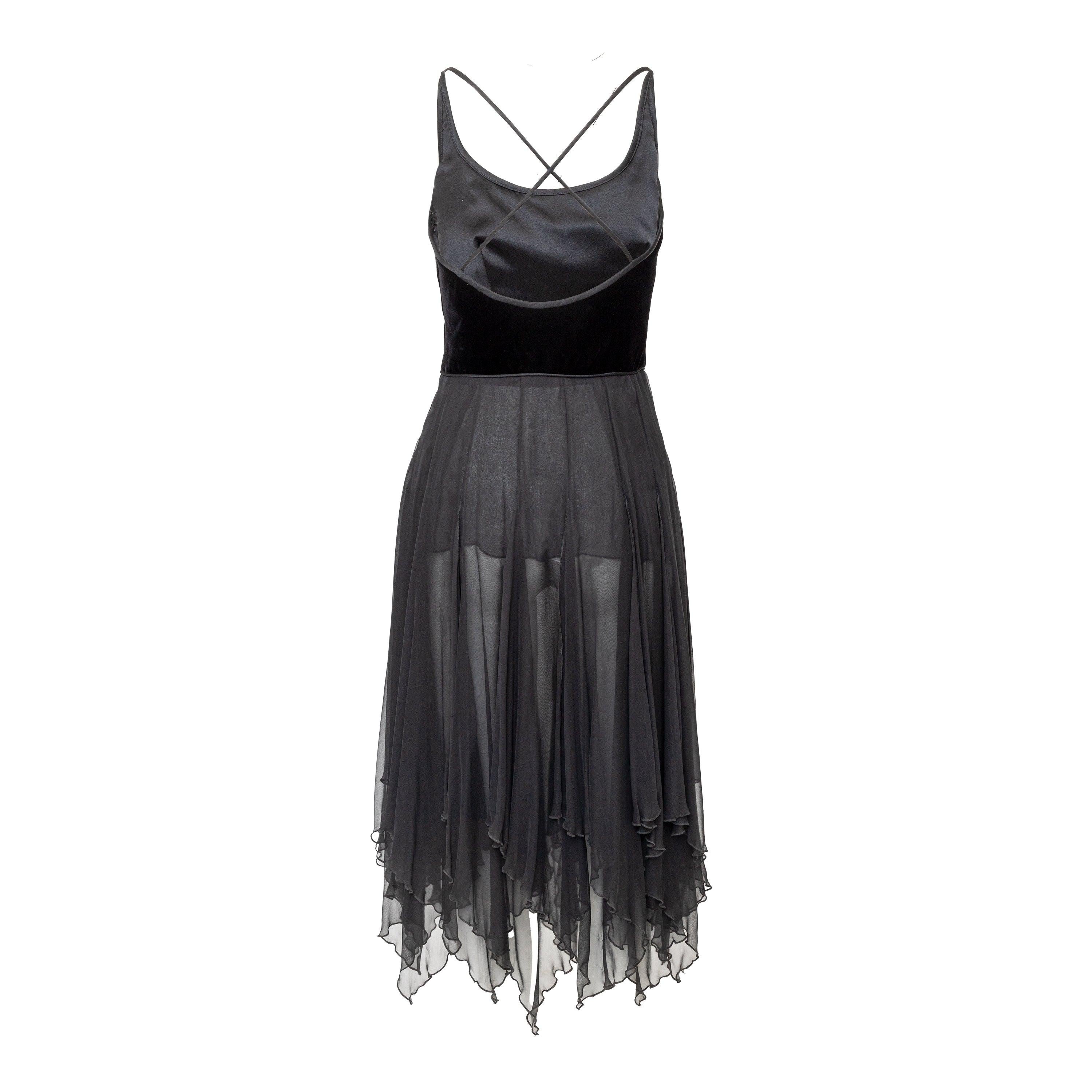 Achieve an iconic 90s look with this Valentino Boutique dress. Made from luxurious silk and velvet, the upper portion features a cross strap back while the lower chiffon half cascades to a midi length. With a hidden zipper at the side, this dress