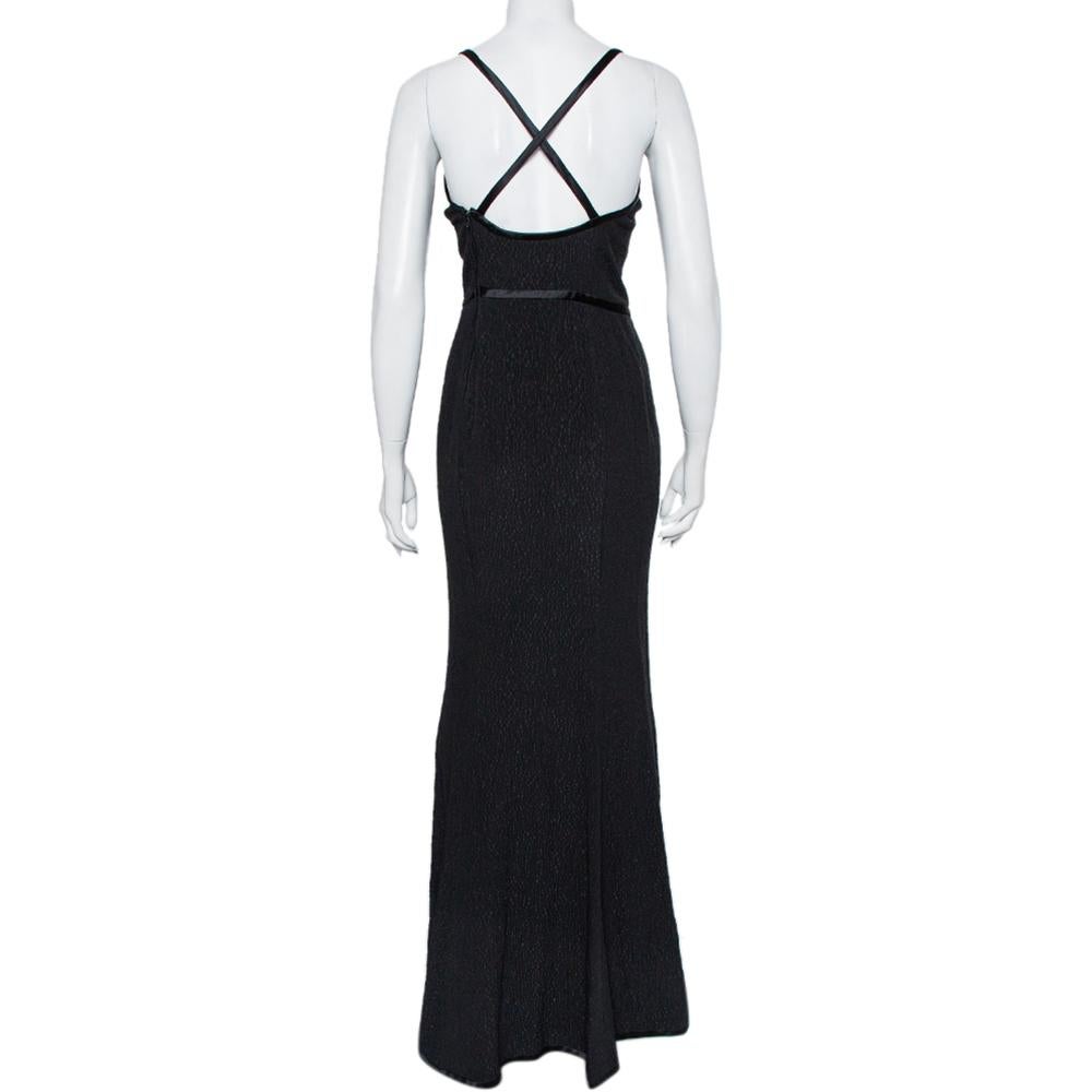 Look regal and classy when you wear this Valentino Boutique dress. This sleeveless maxi dress has been crafted from pure silk and flaunts a classic black hue. The vintage dress has a flattering cross-back style while the cinched waist is detailed