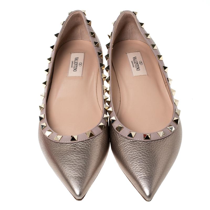 Look glamorous no matter what you wear with these beautiful bronze leather flats. Keep it simple yet gorgeous in these flats from the house of Valentino. They feature pointed toes, leather insoles and rockstud accents.

Includes: Original Dustbag,