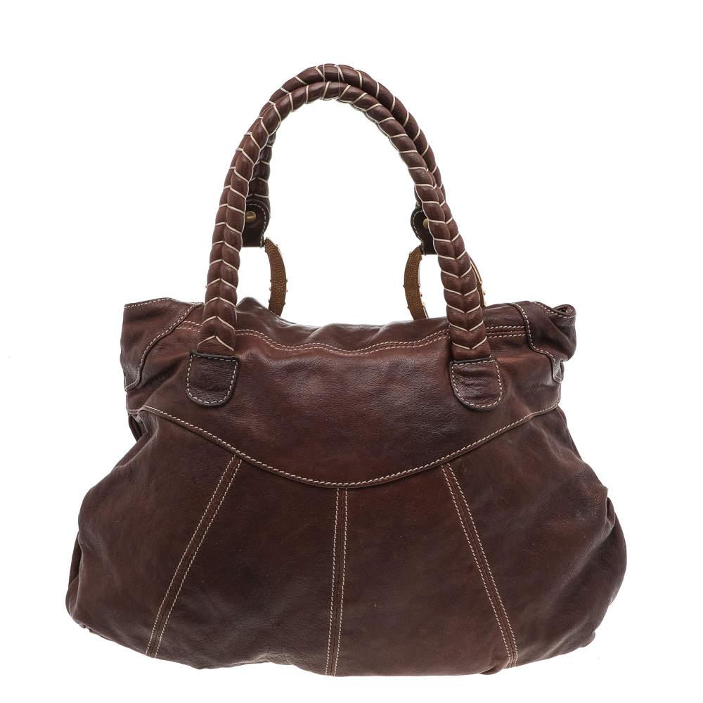 This Valentino handbag is perfect for day-to-night events! It is made from brown leather and comes with dual braided handles, gold-tone hardware, and a roomy fabric interior. It will match well with most outfits!

