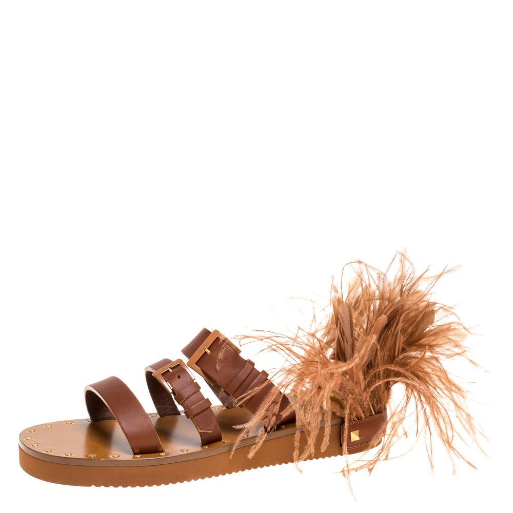 Comfortable and stylish at the same time, these slide sandals from Valentino will help you fashion a statement look. They are crafted from brown leather in an open toe silhouette and styled with three straps across the vamps. They come equipped with