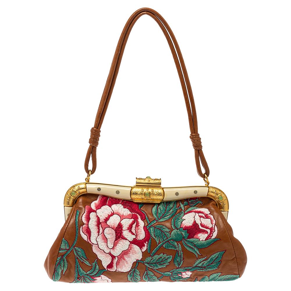 Giving Baguette bags an elegant update, this creation by Valentino will be a valuable addition to your closet. It has been crafted from leather and styled with gold-tone hardware and floral embroidery. It comes with a single handle and a perfectly