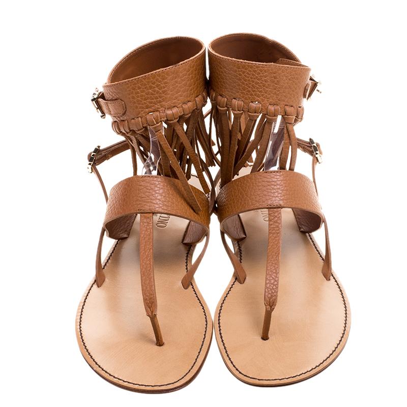 Coming from the house of Valentino, these sandals feature a brown leather fringe detail that lends it a Boho-chic vibe. It comes with an ankle wrap style strap secured with a gold-tone buckle. Wear with everything from fluid dresses to