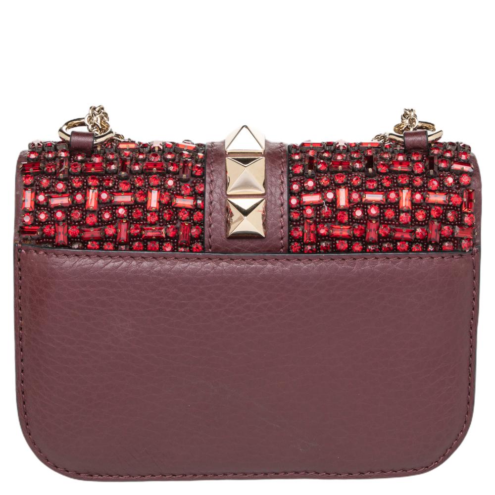 Valentino’s famed Glam Lock bag is taken to glamorous new heights. This brown leather style comes adorned with matching crystal embellishments set into the top flap and finished with a strip of chunky Rockstuds. Consider it the perfect full stop to