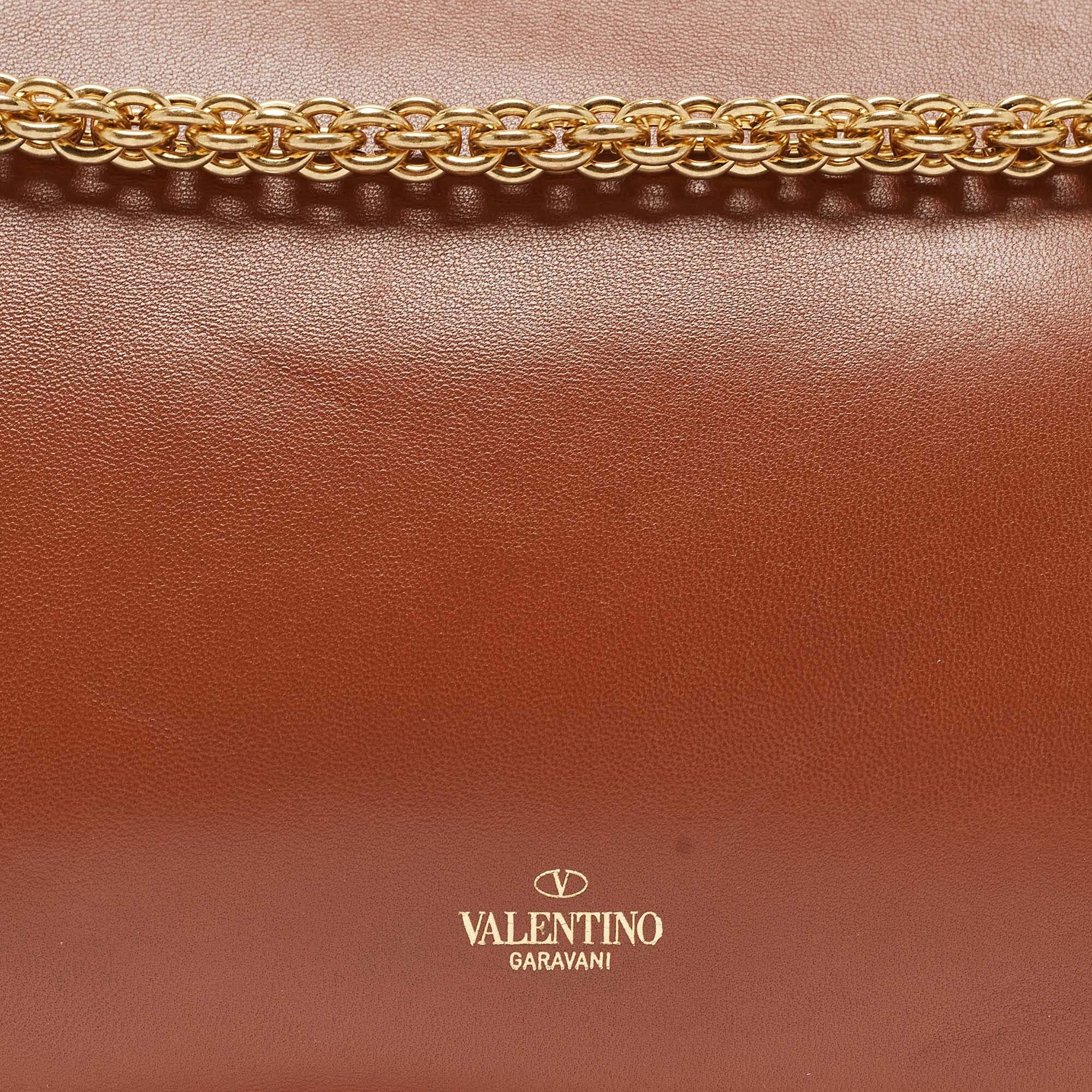 The Valentino handbag is a luxurious accessory crafted with precision. Made from high-quality materials, it features a timeless design with meticulous stitching, signature details, and durable hardware. Well-spaced and stylish, it exudes elegance