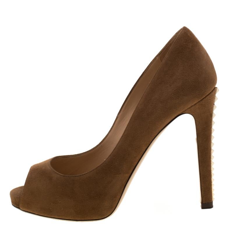 Strike the right pose with these marvellous pumps from Valentino. They've been crafted from brown suede and the 11.5 cm heels are lined with gold-tone studs. Finished with peep toes and platforms, they'll look amazing with your dresses.

Includes: