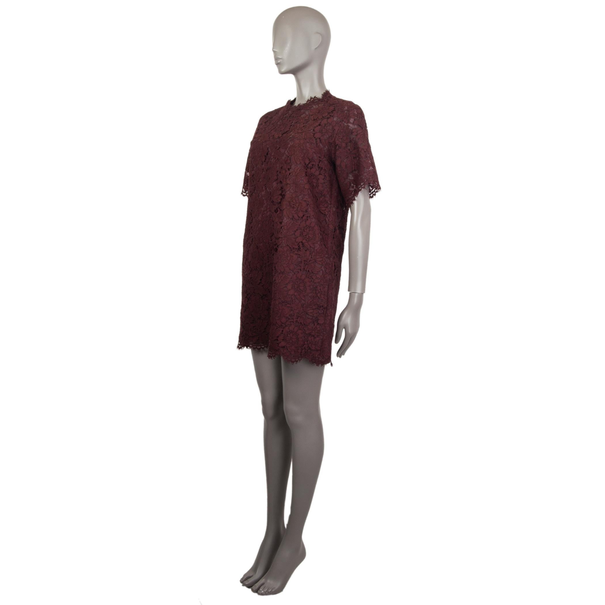 Valentino lace shift dress in burgundy cotton (77%), viscose (17%), and polyamide (6%) with short sleeves and two pockets on the front. Closes with a button and loop on the back. Lined in burgundy silk (91%) and elastane (9%). Comes with a burgundy