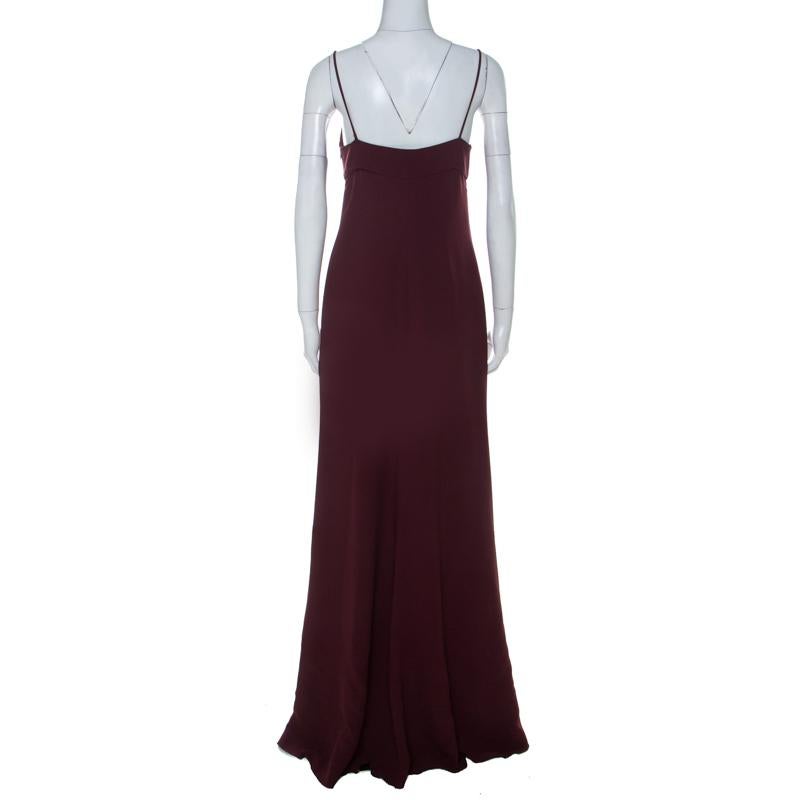 Sway like a dream in this evening gown from Valentino. Tailored to perfection, the burgundy gown has thin shoulder straps, a plunging neckline and a hemline that beautifully falls to the floor. Pair it up with simple heels, accessories and a