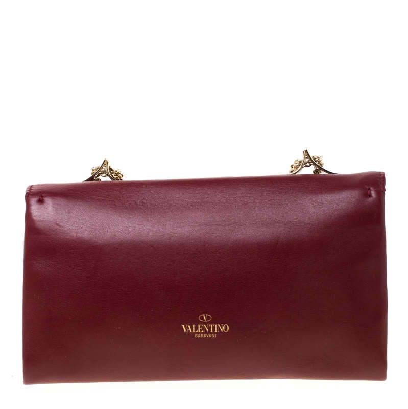 This Va Va Voom shoulder bag from Valentino has a pretty captivating design. Crafted from leather, the bag features gorgeous a flap, a fabric interior, and a shoulder chain. It also comes with a hand slot that is decorated with their signature