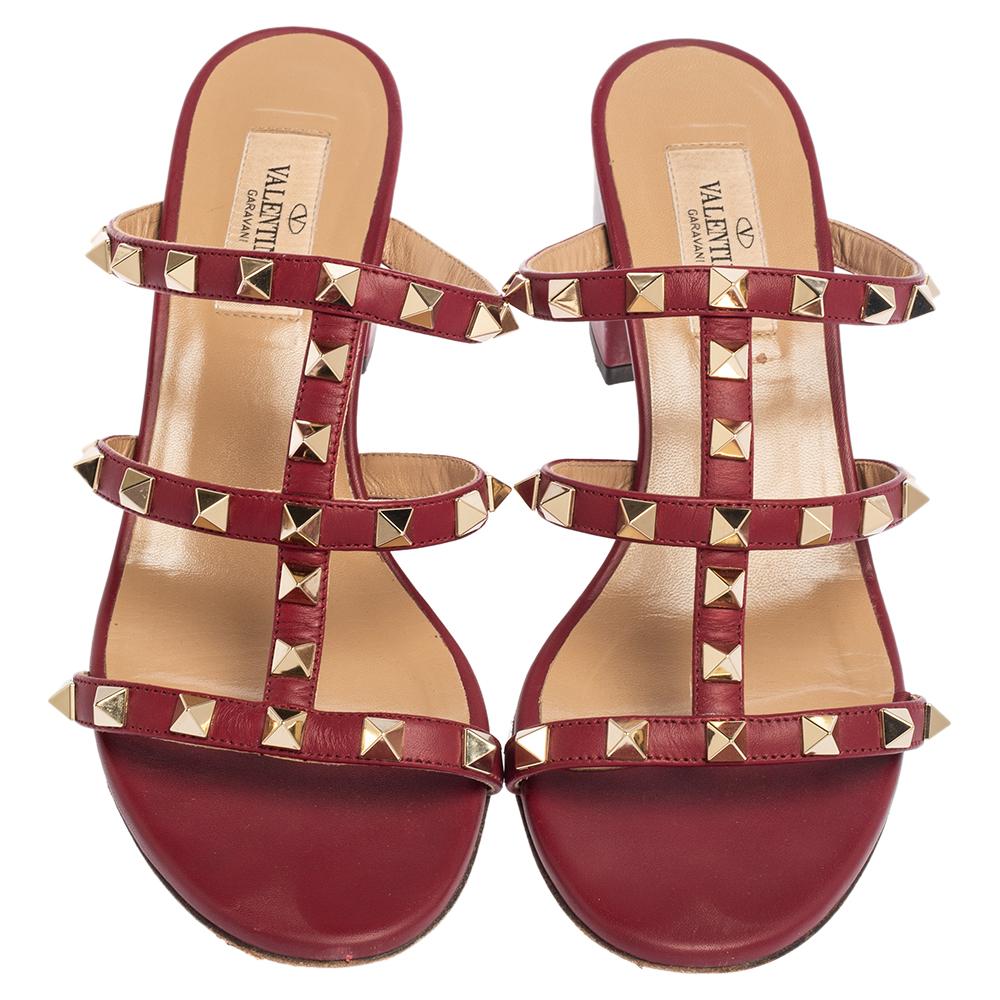 These Valentino sandals are fashioned with burgundy leather to beautifully frame your feet. They are set on block heels and feature Rockkstud accents on the uppers. Wear yours with an LBD or pastel dress to showcase the pair.

Includes: Original