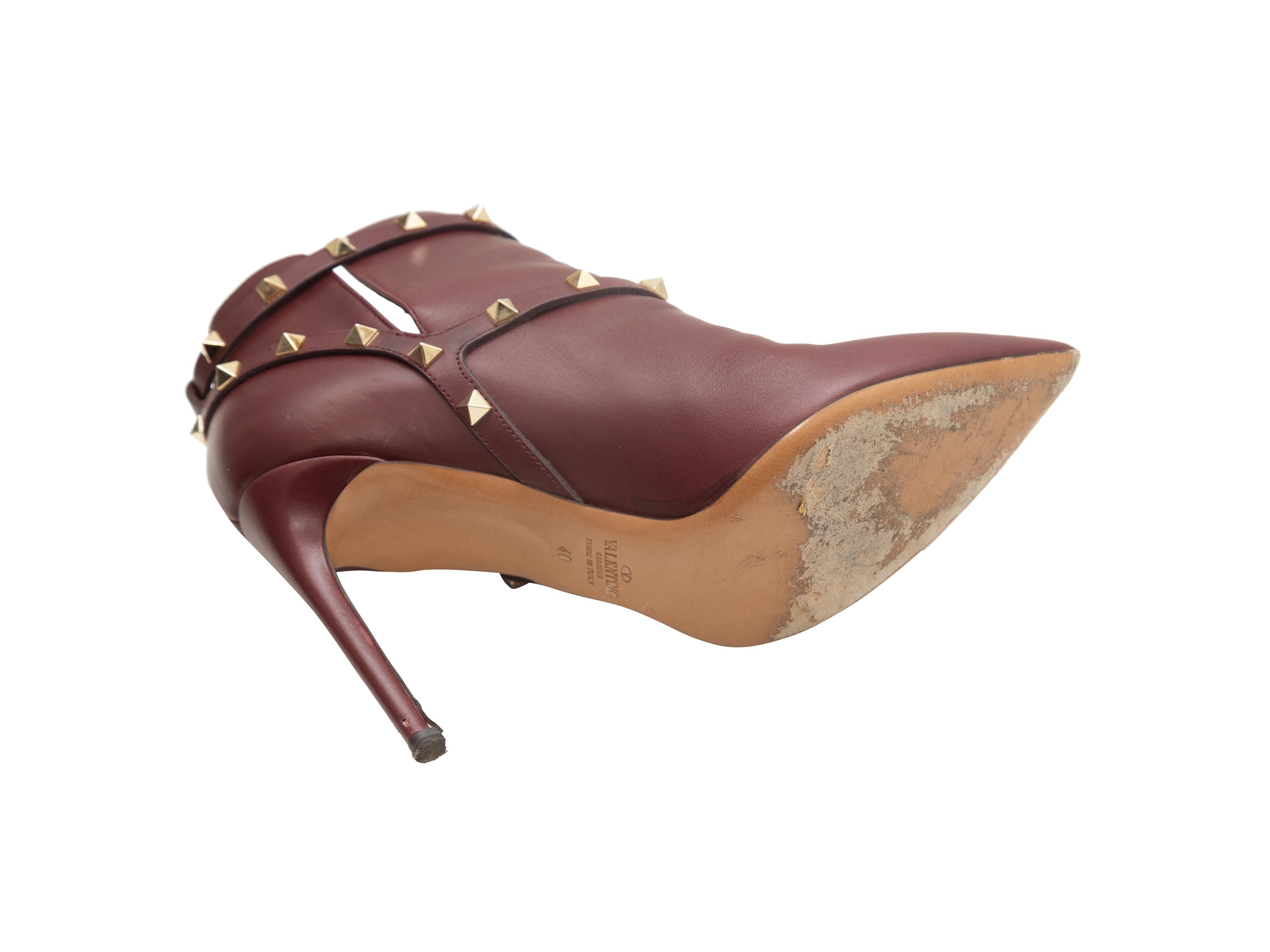 Product details: Burgundy leather pointed-toe booties by Valentino. Gold-tone Rockstud detailing throughout. Designer size 40. 4
