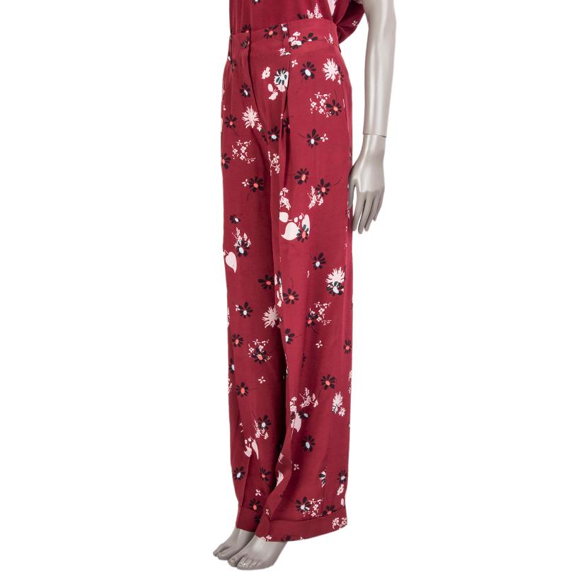 Valentino floral pleated wide pants in raspberry, rose, black, and pale blue silk (100%) with belt loops, two slit-pockets on the sides and two welt-pockets on the back. Close with a concealed zipper and two buttons on the front. Partly lined in