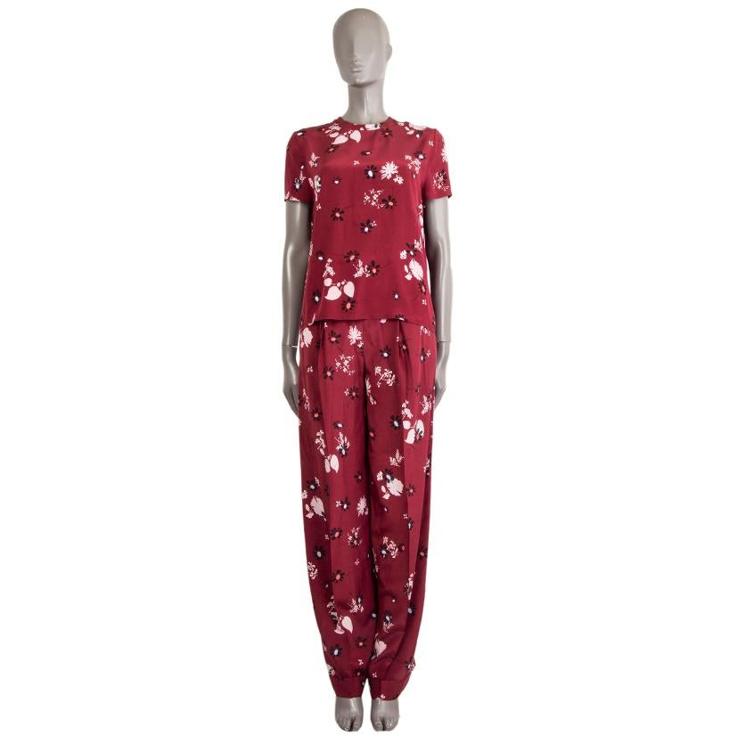 Valentino floral pleated wide pants in raspberry, rose, black, and pale blue silk (100%) with short-sleeves and a key-hole neck. Closes with a matching button on the back. Has been worn and is in excellent condition. 

See separate listing for