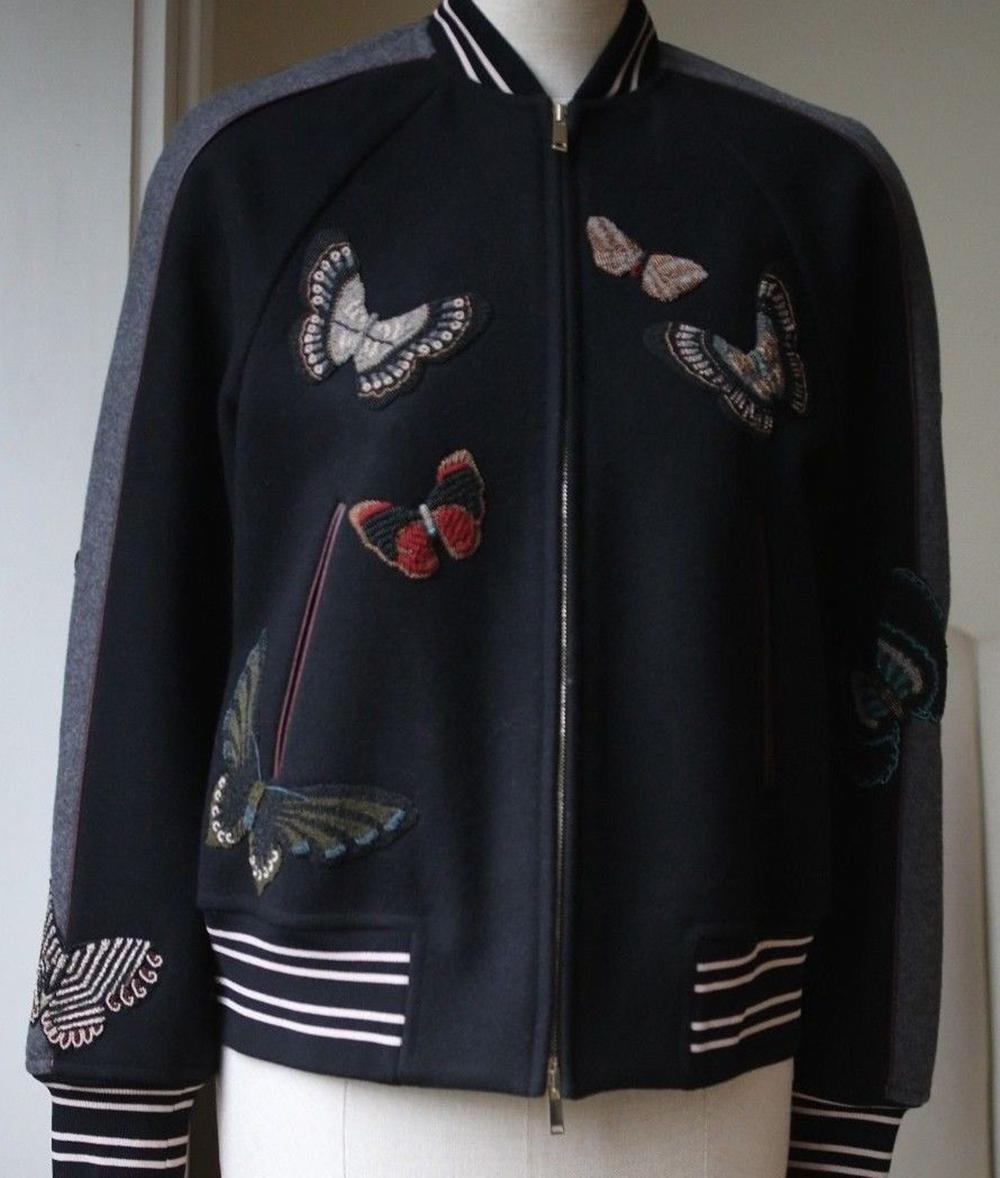 Valentino gives the masculine-inspired bomber jacket a supremely feminine spin this season with beaded butterflies floating elegantly over the sleek silhouette. Crafted from luxe virgin wool in Italy, it is kept city-chic in a monochromatic effect