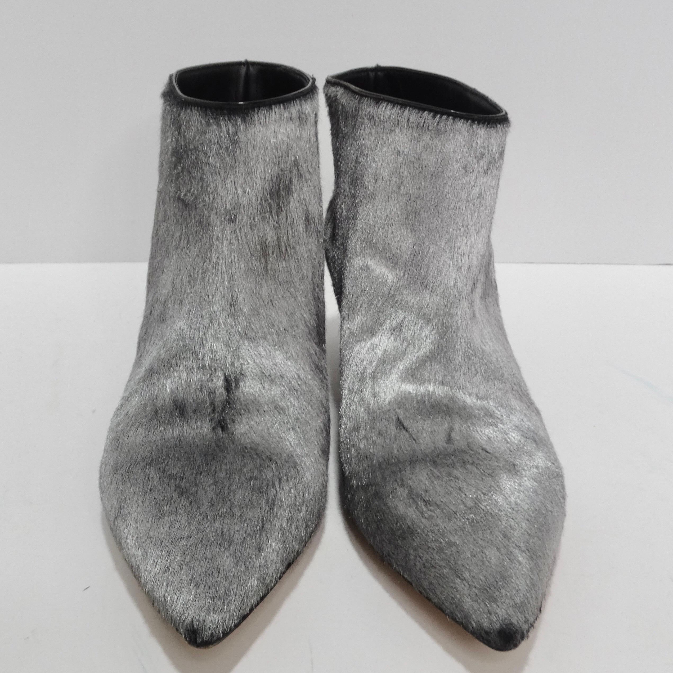 Step into the spotlight with these sensational Valentino Calf Hair Ankle Boots – a statement of unmatched style and luxury. These pointed-toe ankle boots are more than just footwear; they're a work of art. Adorned in shiny grey calf hair, they exude
