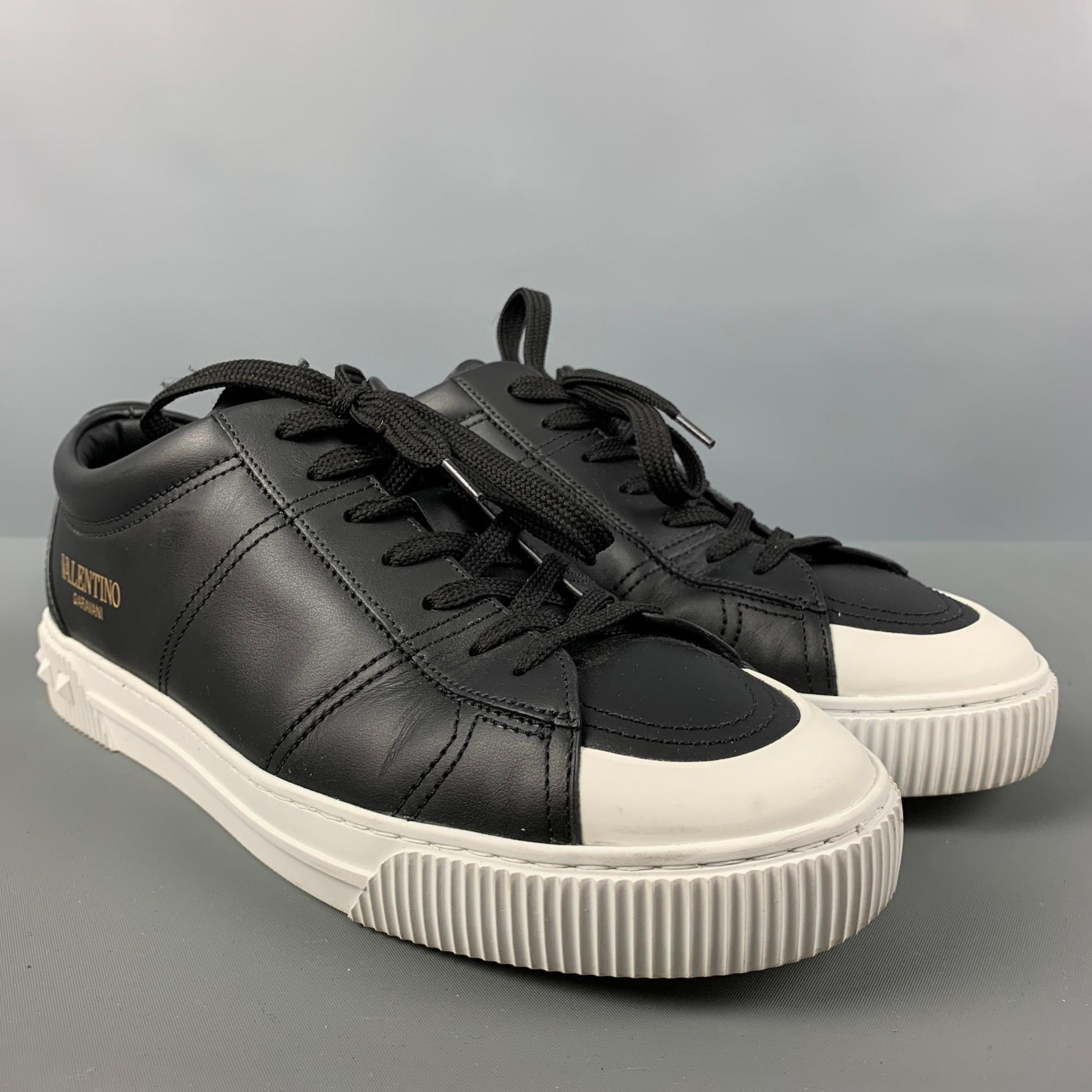 VALENTINO 'City Planet Rockstud' sneakers comes in a black and white leather featuring a low-top style, white studs, and a lace up closure. Made in Italy.

Very Good Pre-Owned Condition.
Marked: S1F90Y2 41

Measurements: 

Length: 11.5 in.
Width: 4