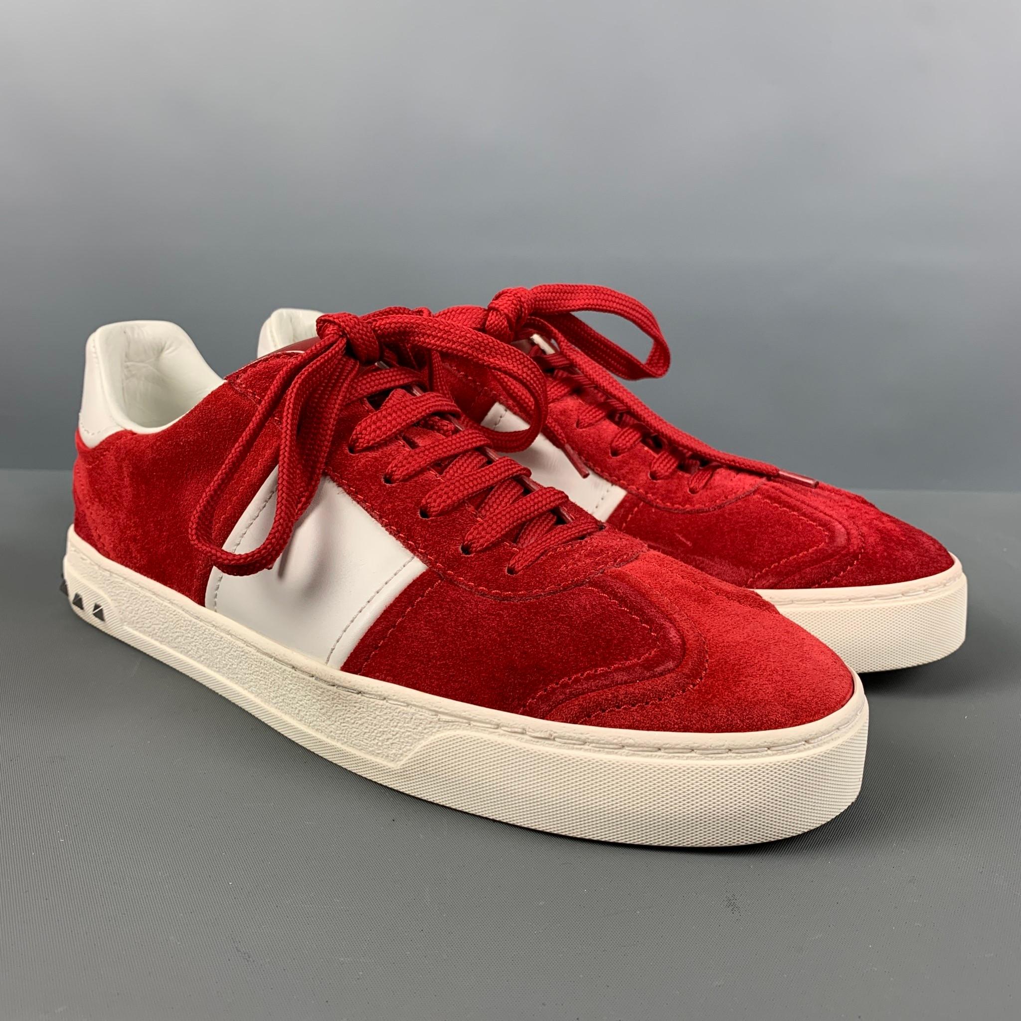VALENTINO 'City Planet Rockstud' sneakers comes in a red and white suede featuring a low-top style, silver studs, and a lace up closure. Made in Italy.

Very Good Pre-Owned Condition.
Marked: TNA08Y2 41

Measurements: 

Length: 11.5 in.
Width: 4 in.