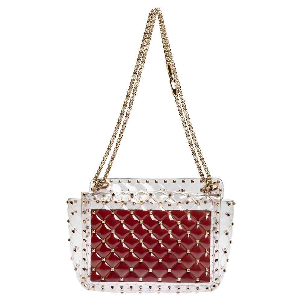 Stylish and elegant, this is the accessory that makes a fashionista stop and admire. The classic design is crafted in Italy and comes in quilted, clear PVC with a chainlink shoulder strap and multiple gold-tone Rockstuds over the body, which is the