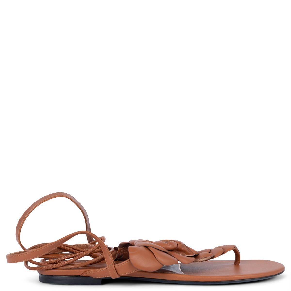 100% authentic Valentino 03 Rose Edition Atelier flower appliqué ankle tie thong flat sandals in cognac brown leather. Have been worn once inside and are in virtually new condition. 

Measurements
Imprinted Size	38.5
Shoe Size	38.5
Inside