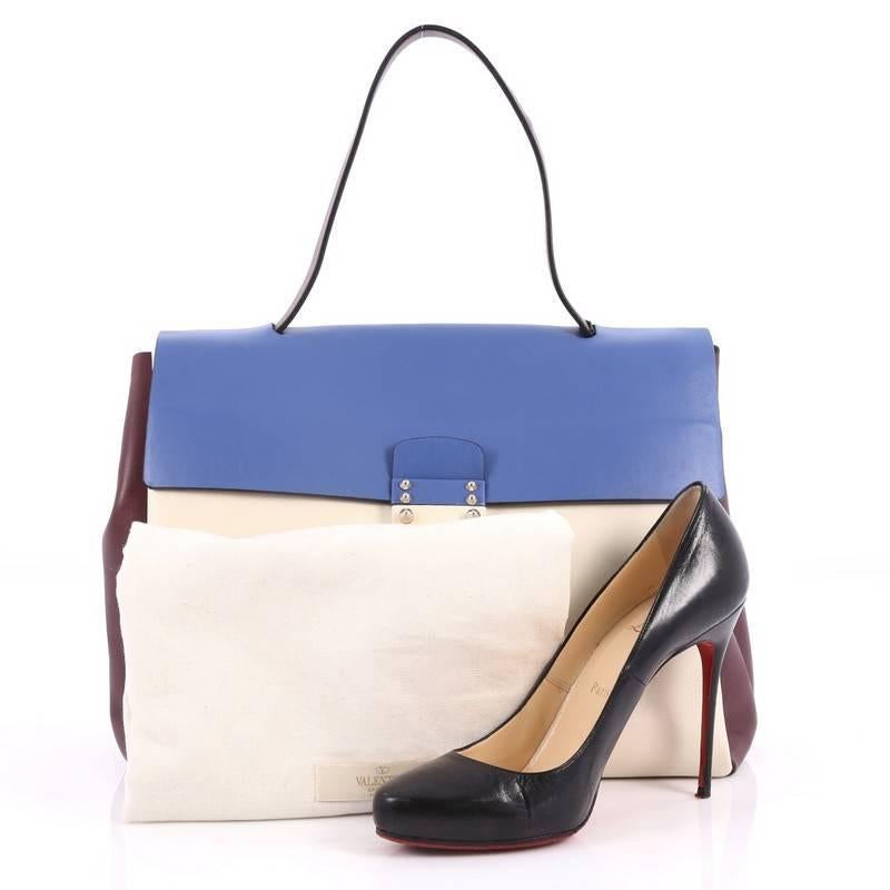 This authentic Valentino Colorblock Mime Handbag Leather Large is from the brand's Spring 2015 Mime Collection. Crafted in white, burgundy and blue leather, this chic handbag features a flat top handle, S-lock closure at front flap and gold-tone