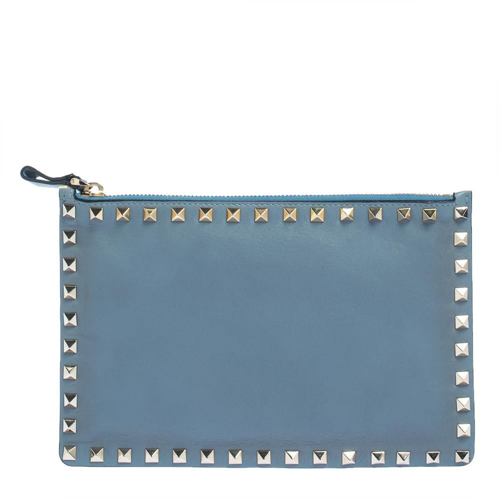 This pouch from Valentino has been made using leather in Italy. It has a beautiful exterior and a fabric-lined interior that is secured by a top zip closure. This pouch is adorned with the signature Rockstuds on the exterior.

