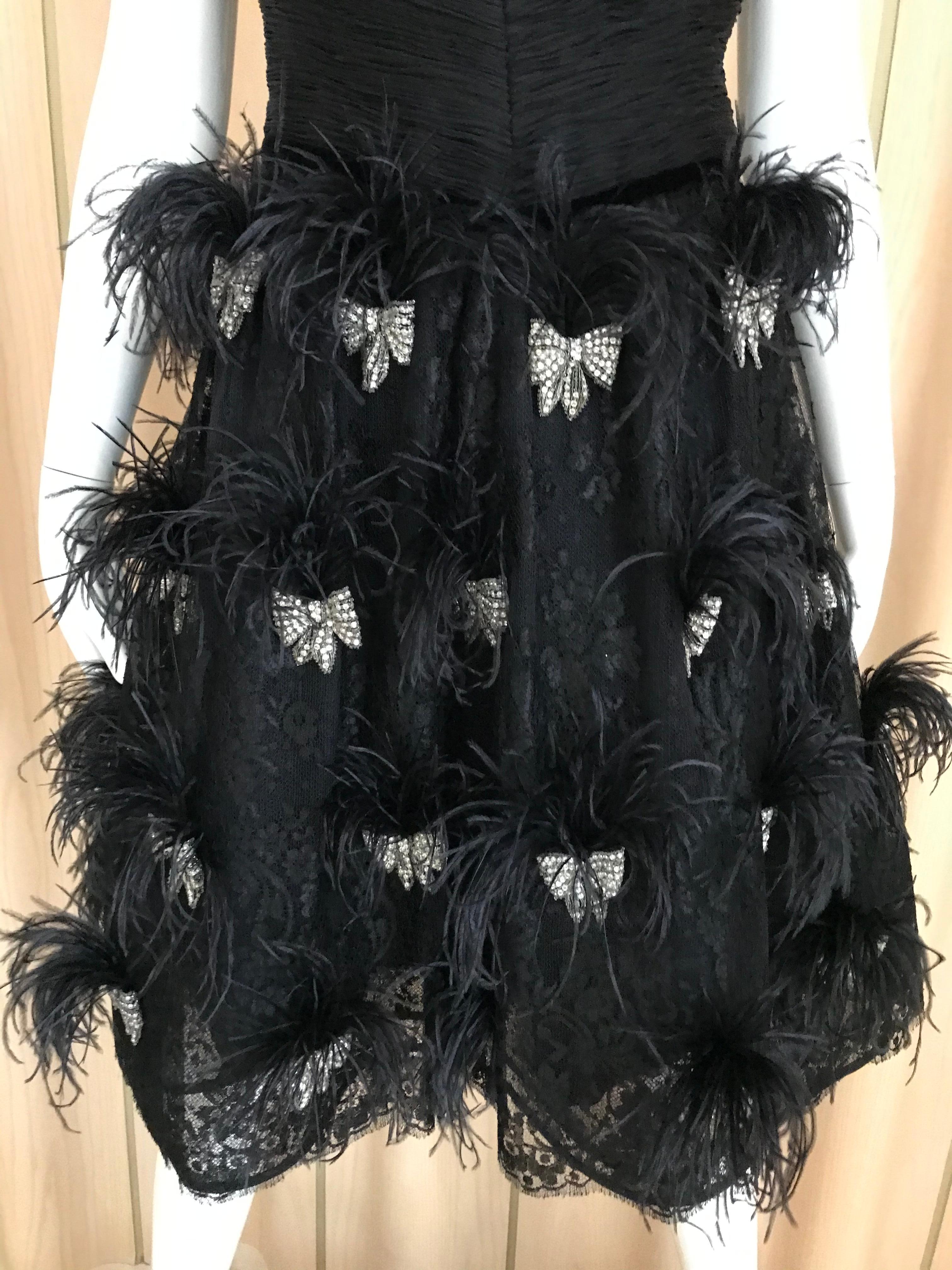 Sexy and Fun Black Silk VALENTINO COUTURE spaghetti strap cocktail dress with ostrich plume.
Bust: 36 inches/ Waist: 30 inches/ Dress length: 38 inches